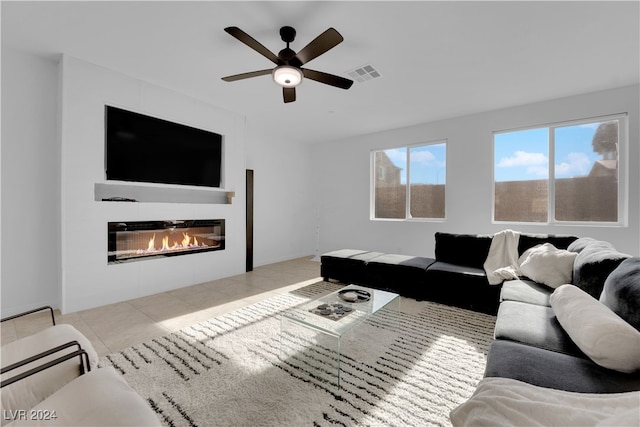 tiled living room featuring ceiling fan