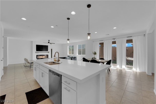 kitchen with sink, an island with sink, white cabinets, decorative light fixtures, and stainless steel dishwasher