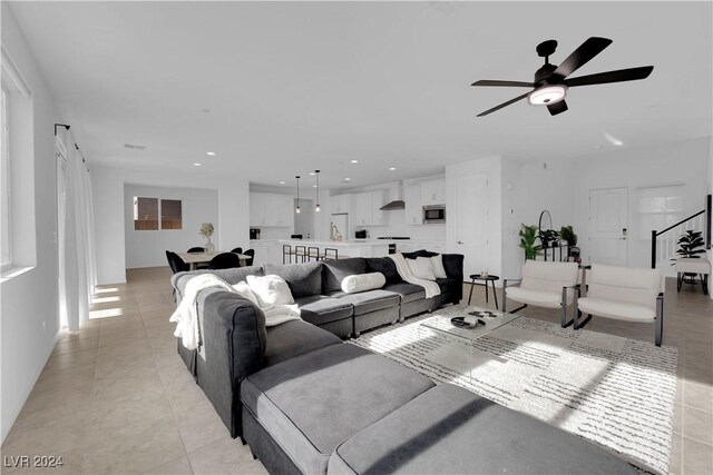 living room with light tile patterned flooring and ceiling fan