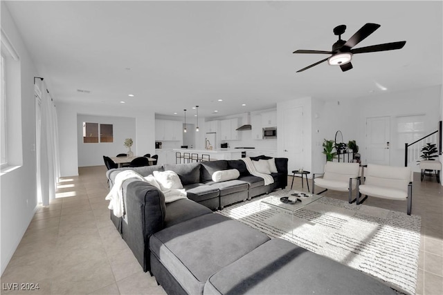 living area with recessed lighting, ceiling fan, and light tile patterned floors