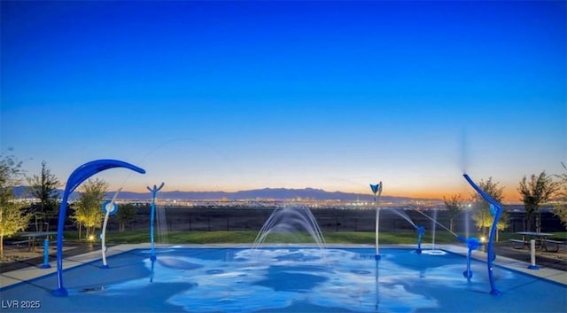 view of pool at dusk