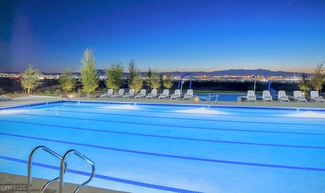 view of pool at dusk