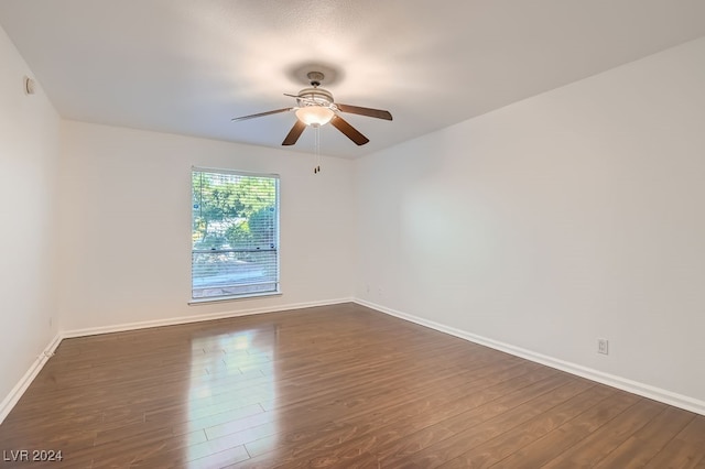 empty room with ceiling fan and dark hardwood / wood-style floors