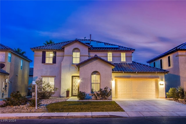 mediterranean / spanish-style house featuring a garage