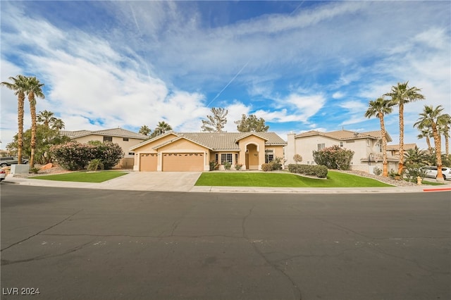 view of front of property with a front yard and a garage