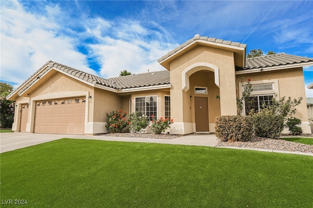 view of front of house with a garage and a front lawn