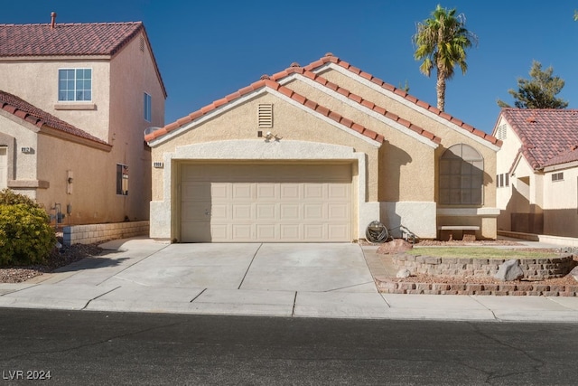 mediterranean / spanish-style home featuring a garage