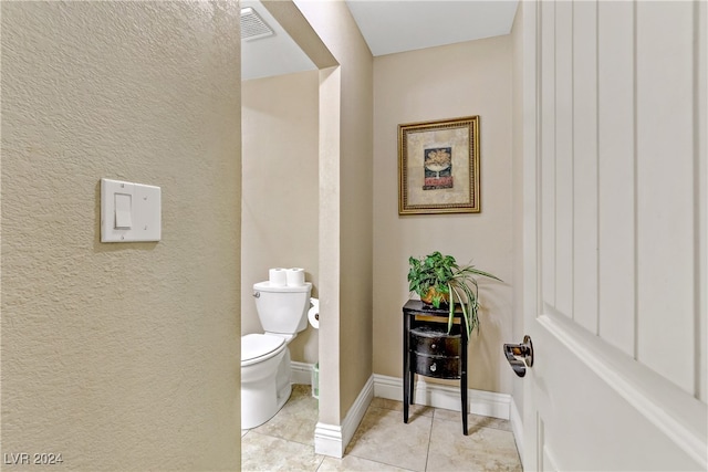 bathroom featuring toilet and tile patterned floors