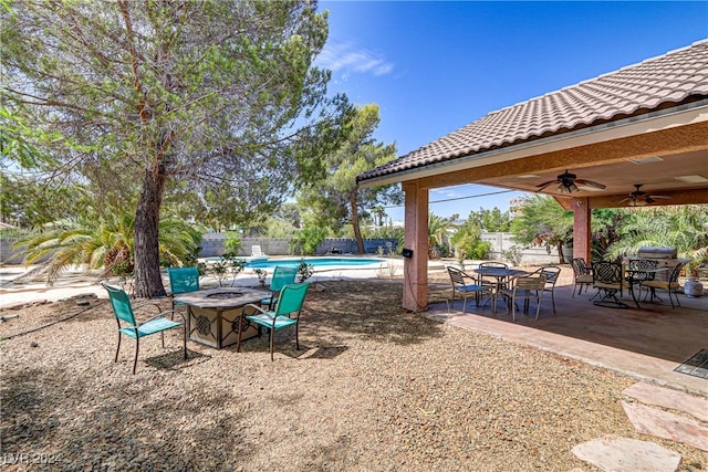 view of yard featuring ceiling fan and a patio