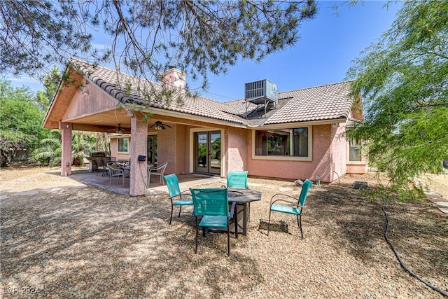 rear view of house with ceiling fan, central air condition unit, and a patio area