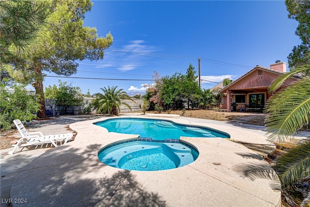 view of swimming pool with an in ground hot tub and a patio area