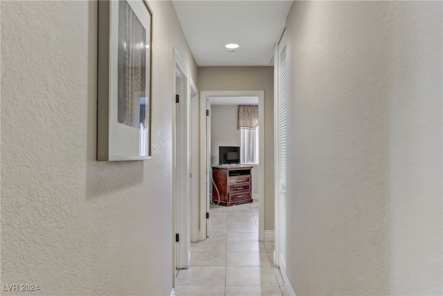 hall with light tile patterned floors