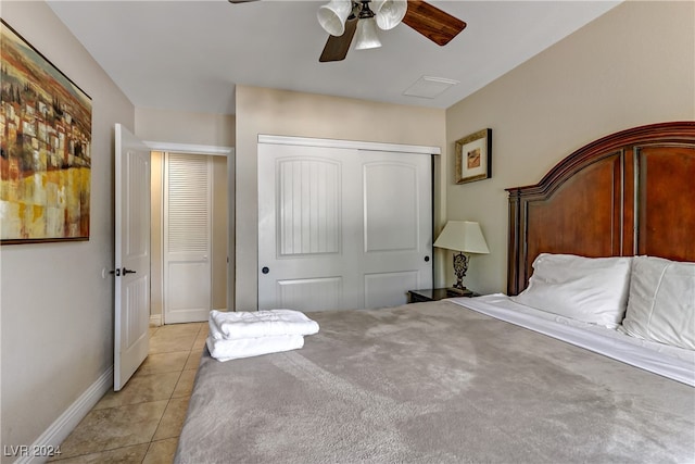 bedroom with light tile patterned floors, ceiling fan, and a closet