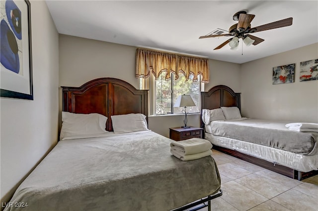 tiled bedroom with ceiling fan