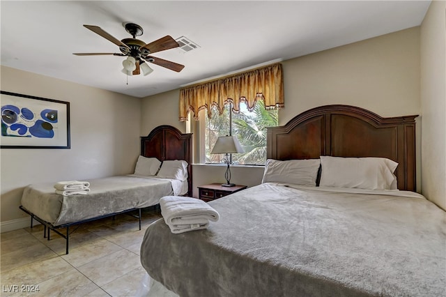 tiled bedroom with ceiling fan