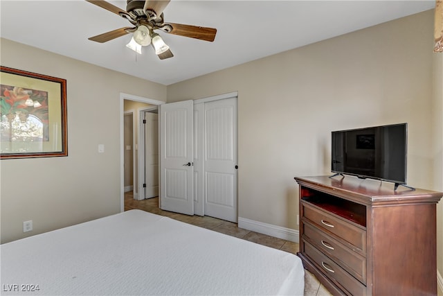 bedroom with a closet, ceiling fan, and light tile patterned floors