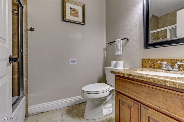 full bathroom featuring enclosed tub / shower combo, vanity, toilet, and tile patterned floors