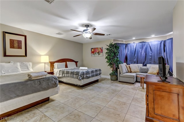 tiled bedroom featuring ceiling fan