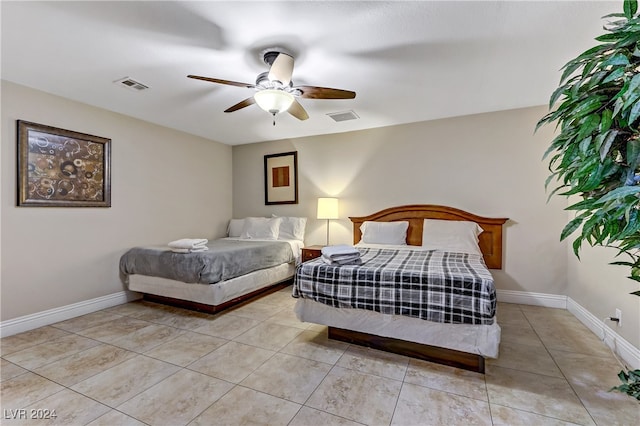 bedroom with ceiling fan and light tile patterned floors