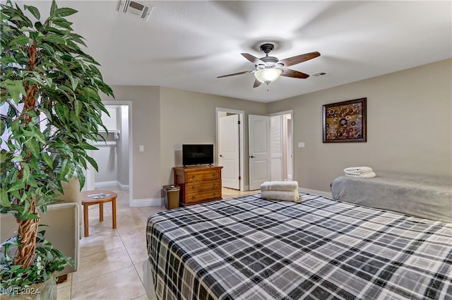 tiled bedroom featuring ceiling fan