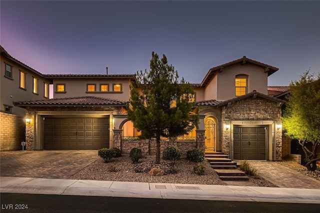 mediterranean / spanish home featuring a garage