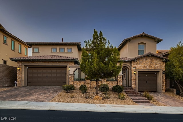 mediterranean / spanish-style home with a garage