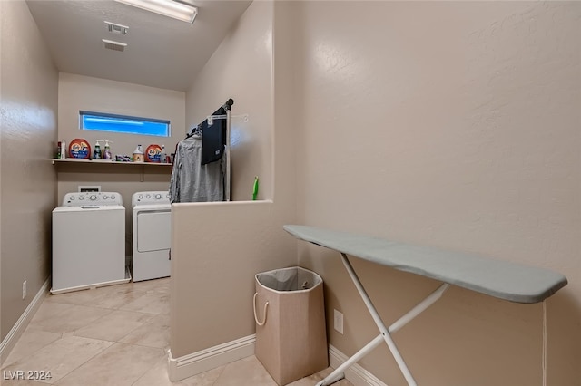 washroom featuring tile patterned flooring and washer and dryer