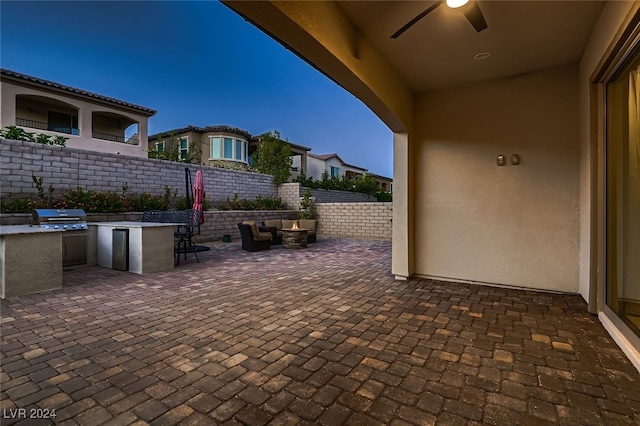 view of patio / terrace with ceiling fan, area for grilling, and exterior kitchen