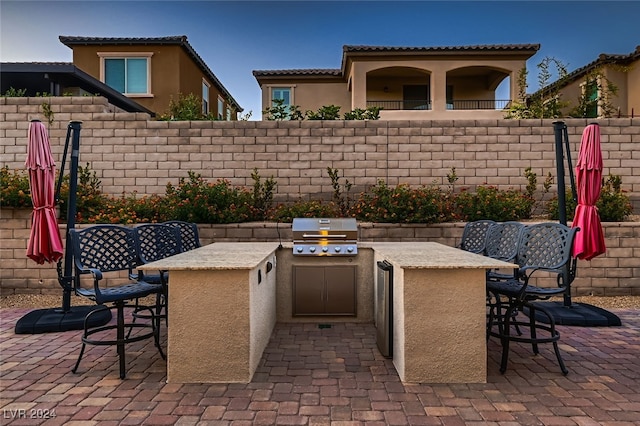 view of patio / terrace with exterior kitchen, exterior bar, and a grill