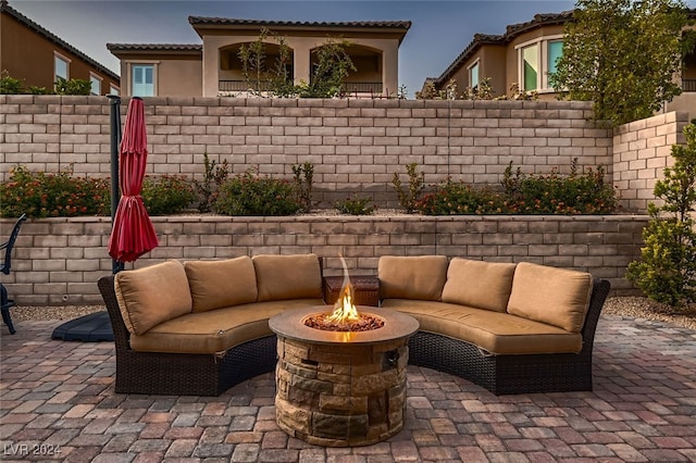 view of patio / terrace with an outdoor living space with a fire pit