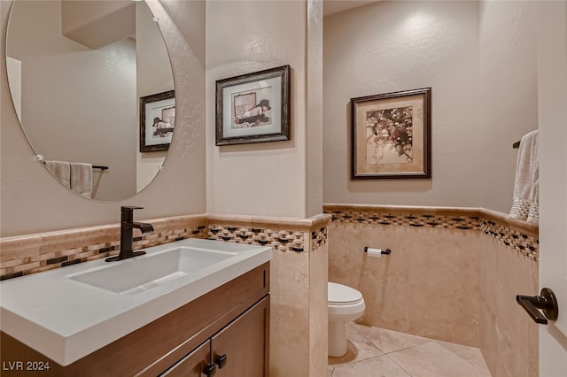 bathroom with tile walls, tile patterned floors, vanity, and toilet