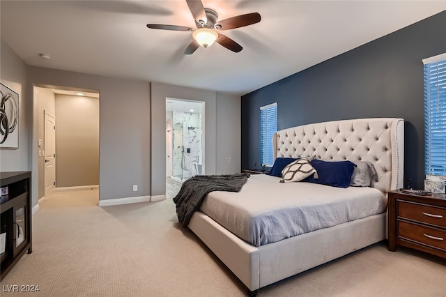 bedroom with connected bathroom, ceiling fan, and light colored carpet