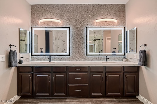 bathroom featuring walk in shower, vanity, and hardwood / wood-style flooring