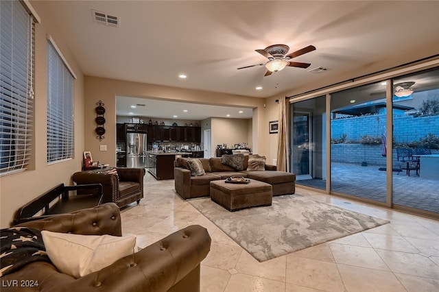 tiled living room with ceiling fan