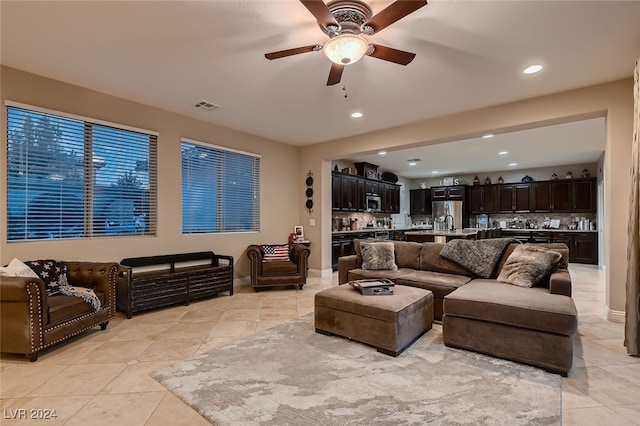 tiled living room with ceiling fan