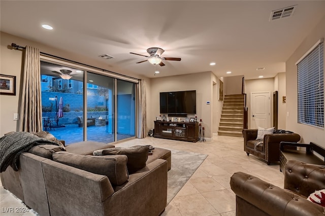 living room featuring light tile patterned floors and ceiling fan