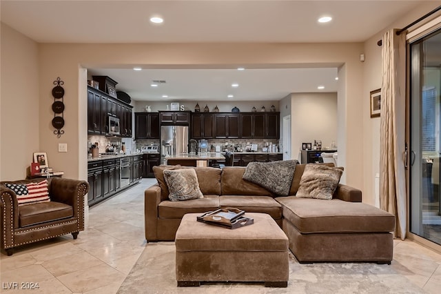 living room featuring wet bar and light tile patterned floors