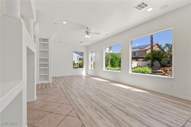 unfurnished room featuring ceiling fan and light hardwood / wood-style floors