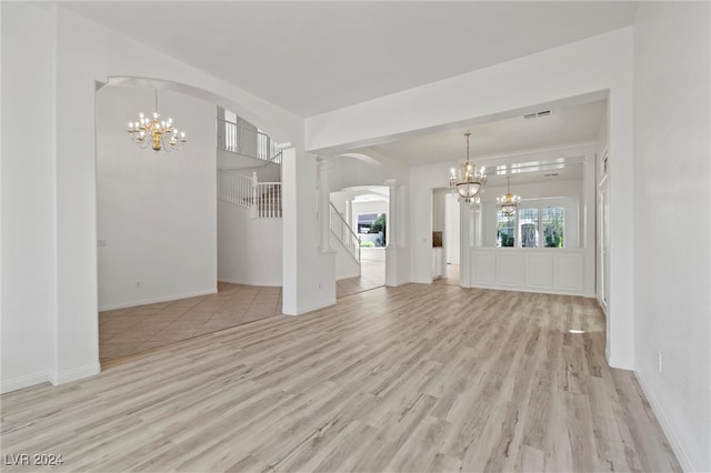 interior space featuring light wood-type flooring and a chandelier