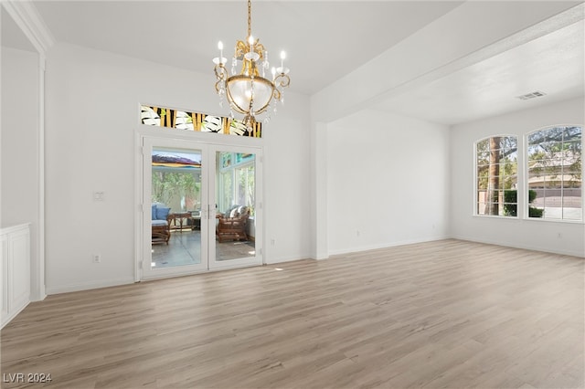 interior space with light hardwood / wood-style flooring and a notable chandelier