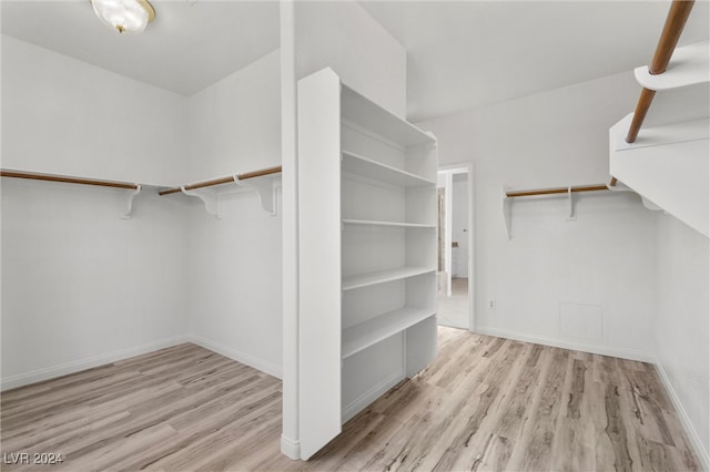 spacious closet with light hardwood / wood-style floors