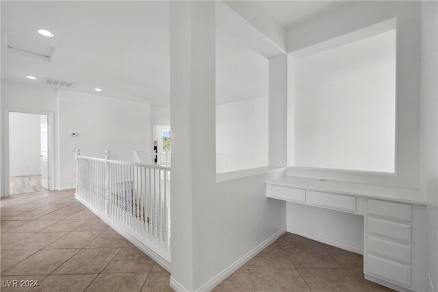 corridor featuring light tile patterned floors