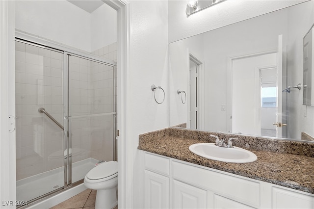 bathroom with vanity, toilet, tile patterned floors, and an enclosed shower