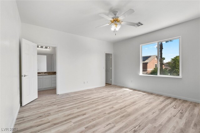 unfurnished bedroom with ensuite bath, light hardwood / wood-style flooring, sink, and ceiling fan