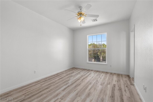 spare room featuring light wood-type flooring and ceiling fan