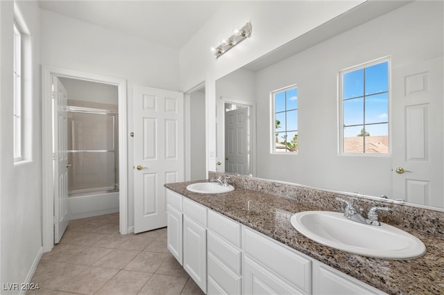 bathroom featuring vanity, tile patterned floors, and bath / shower combo with glass door