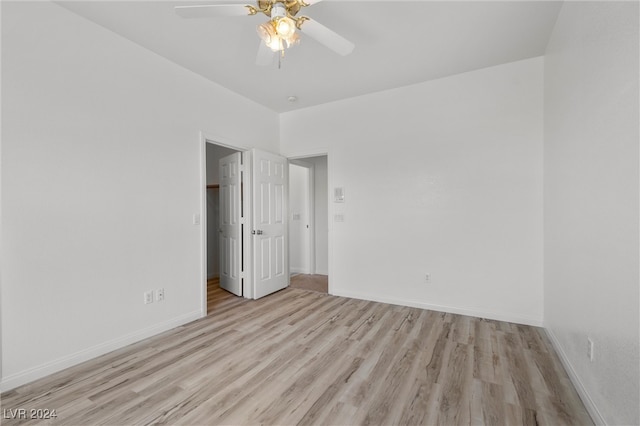 unfurnished bedroom with ceiling fan and light hardwood / wood-style flooring