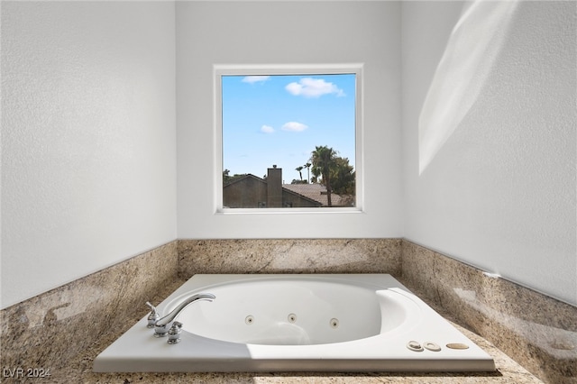 bathroom with a tub to relax in