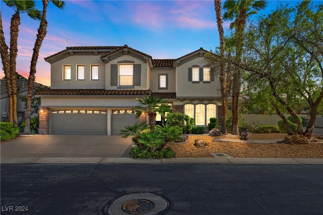 mediterranean / spanish-style home featuring a garage