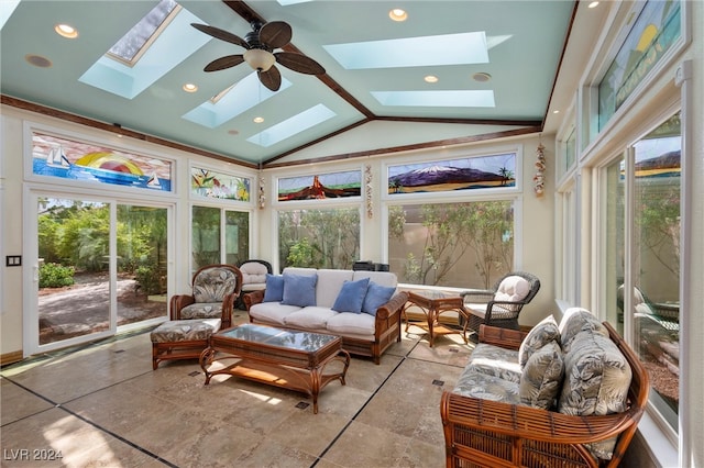 sunroom featuring lofted ceiling with skylight and ceiling fan